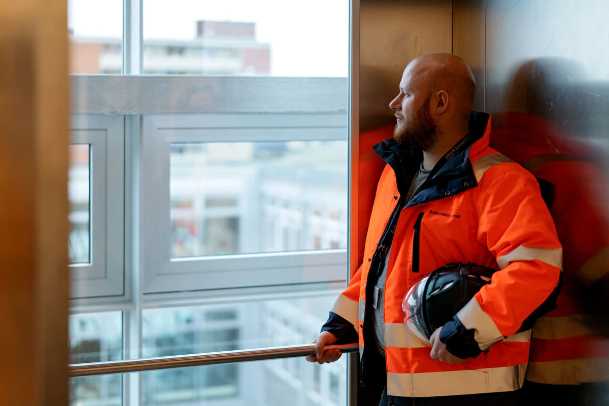 Tilsynsførende står i en elevator